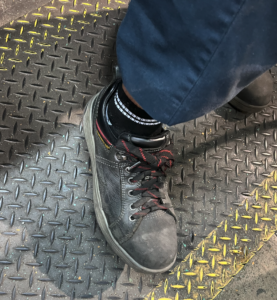 Technician Is Wearing Long Sleeve Pants & Steel Toed Boots
